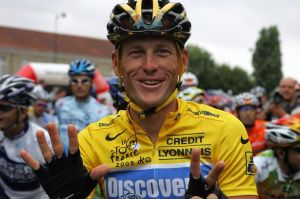 Lance uses his fingers to demonstrate the amount of times he's taken performance enhancing drugs
